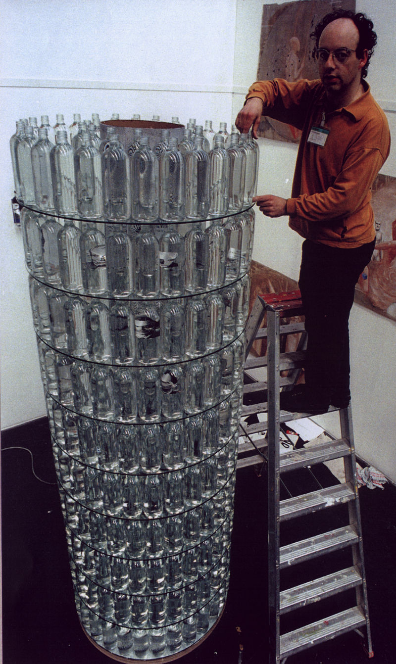 860 Janever bottles filled with water, with photo-images, and glass, Height 4 metres, diameter 89 cm, 1996.